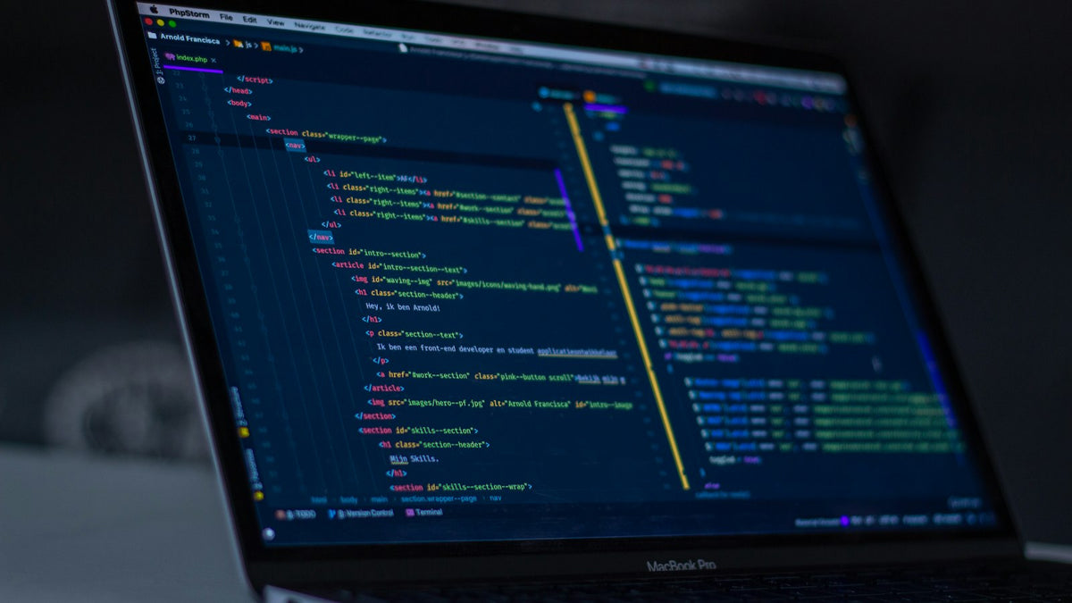 Laptop showing code during a WordPress to Shopify migration