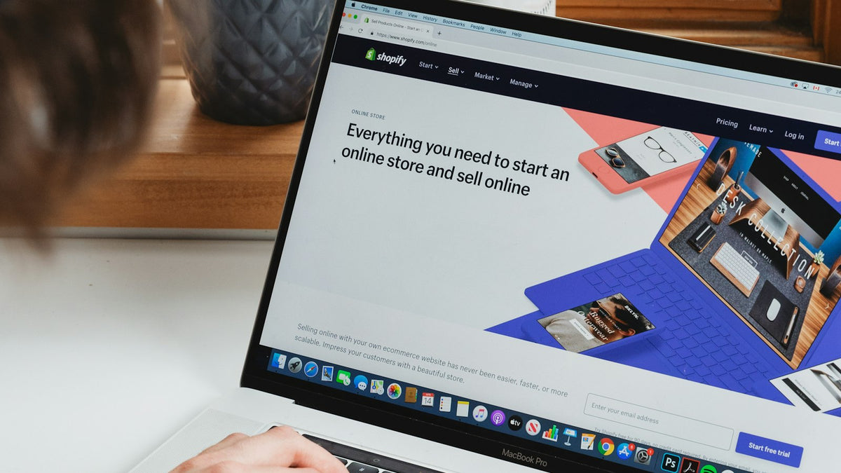 Business owner comparing website platforms on a laptop