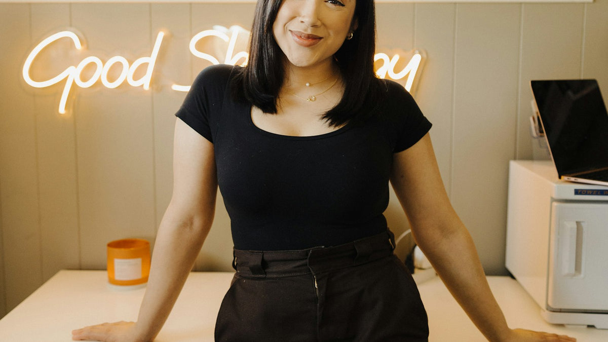 Shop owner standing at a counter ready to help customers