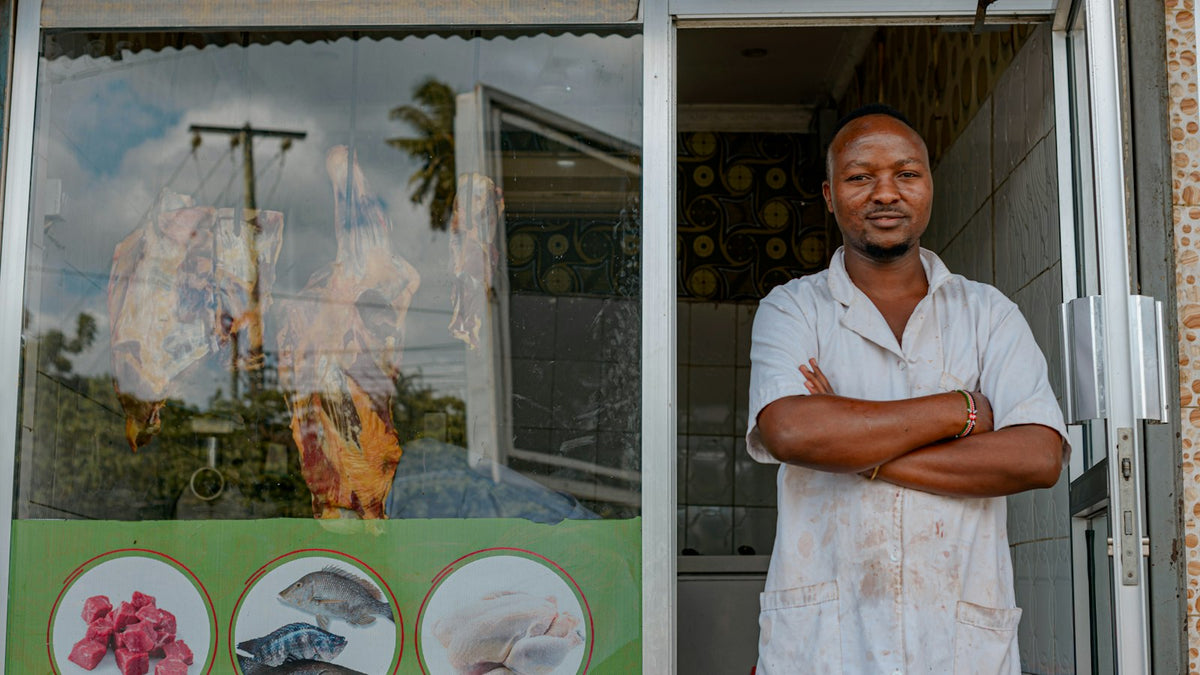 Business owner standing proudly outside his store